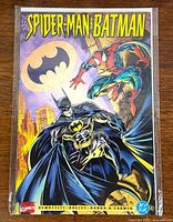 Front cover of bagged comic showing Spider-Man and Batman artwork