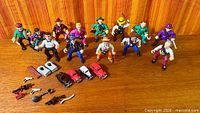 Group shot of 12 figures, four vehicles and accessories