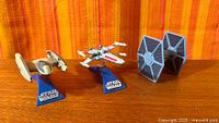 Three Star Wars die-cast ships on stands
