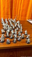 Wide view of all unpainted metal miniatures on bases