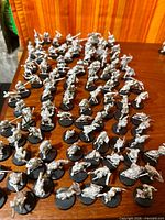 Wide view of bulk of assembled metal Uruk-hai miniatures on bases