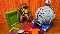 Group shot showing Technodrome, Donatello figure, Mutant Maker frame, accessories