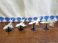 Four Eldar Solaris Class cruiser miniatures on stands