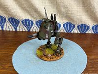 Front three-quarter view of painted Sentinel Walker showing cockpit, weapon and base