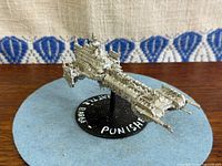 Side-front view of the die-cast Space Marine Battle Barge on flight stand