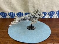 Side view of Imperial Cruiser miniature on stand
