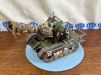 Left side view showing full tank, cannon, crew and base