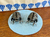 Top view of both diecast Necron Scarab miniatures