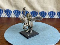 Side view of assembled metal Pegasus rider on black base