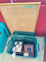 Large gold-tone poster frame and bin of assorted brown/mahogany wood picture frames