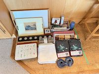 Lot overview showing tray, linens, candle accessories, aprons and holders