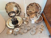 Full lot showing trays, candlesticks, covered dish, glass cups in holders, small dishes and spoons