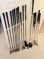 Full view of all clubs leaning against wall