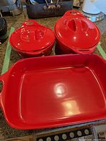 Entire red stoneware set: rectangular baker, two lidded casseroles