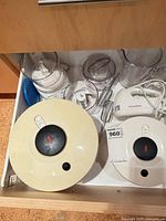 Drawer view showing two salad spinner lids, food processor bowls, hand mixer and tag