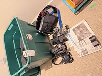Overview showing Sony camcorder, camcorder case, cables, manuals and storage tote