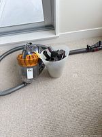 Dyson DC37 vacuum with hose, wand, floor head, attachments in caddy