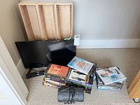 Overall lot including TV, remote, clock radio, CD racks, DVDs, VHS