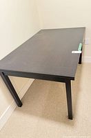 Full view of rectangular dining table showing top, legs, finish