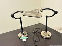 Pair of Lights of America desk lamps on table