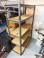 Front angled view of full shelving unit showing metal frame and five MDF shelves