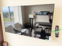 Front view of Samsung 48-inch TV wall-mounted on light wall