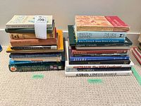 Two stacks of books separated by green tape labels; left natural science, right travel