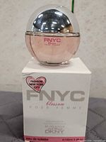 Front view of FNYC Blossom perfume bottle on box, showing brand and design