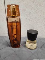 Guess Marciano and Burberry Touch fragrance bottles side by side