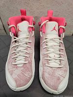 Front view of both shoes showing laces, tongues, Jumpman logos, toe condition