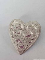 Front view of sterling heart brooch showing engraved floral design