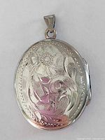 Front view showing engraved floral design and bail