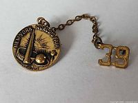 Front view of brooch and attached 39 charm showing overall design