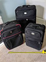 Three suitcases side by side showing size differences and front panels