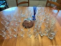 Full lot overview showing all stemware, blue flutes, rocks glasses and cheese dome