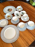 Overview of assorted dinnerware and tea items on table