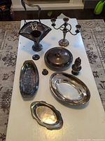 All eight silver-plated items displayed on table