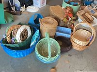 group of assorted painted and natural wicker baskets on floor