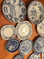 Group of assorted blue and white plates and bowls displayed on table
