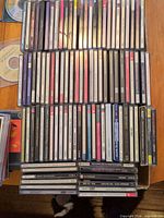 Top view of multiple rows of CD jewel cases showing titles and spine labels