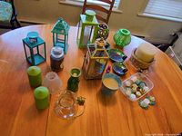 overall view of assorted lanterns, candles, mosaic dishes, holders on table