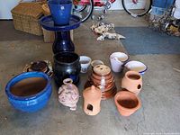Group view of all planters and bird bath pieces on floor