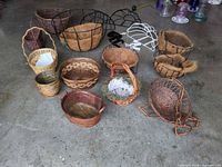 Overview of baskets, planters and brackets spread on floor