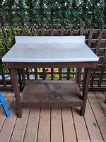 Full view of potting bench front showing work surface, frame, lower shelf