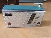 Front view showing RCA Victor badge, metal grille, dial, tuning knob