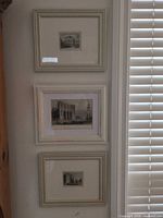 All three framed prints hanging vertically