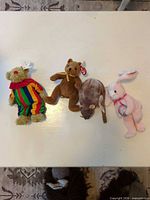 Four Beanie Babies laid out side by side