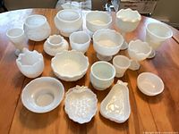 all milk glass pieces arranged on table showing variety