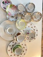 All teacups, saucers and plates laid out on table