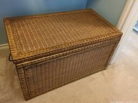 closed wicker and wood blanket chest showing exterior weave and overall condition